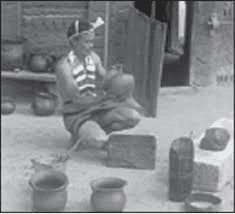 A man making pots in his courtyard- example of household industry in  Nagaland